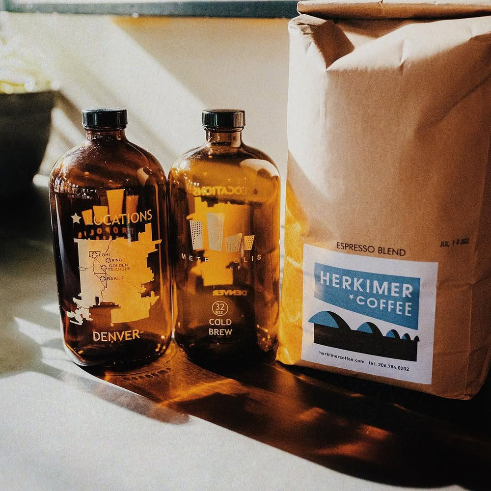 Metropolis cold brew bottles beside Herkimer Espresso Blend