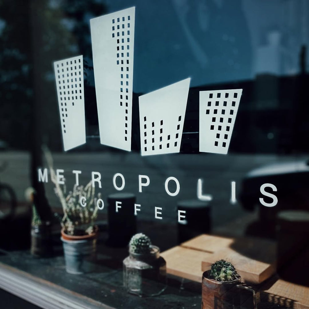 Metropolis Coffee window logo and plants
