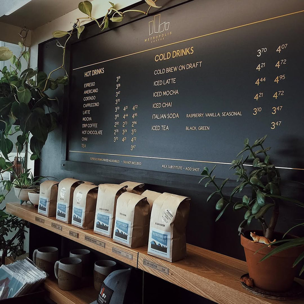 Herkimer coffee bags beneath a Metropolis cafe menu