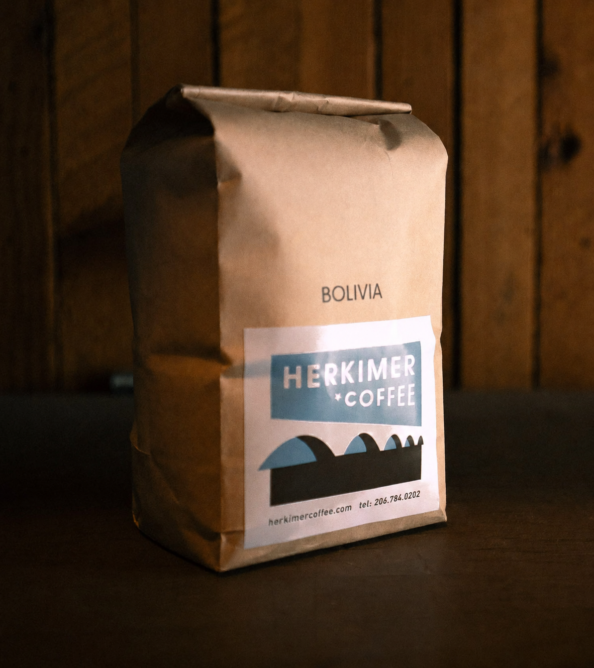 Bolivia whole bean coffee by Herkimer Coffee on a wooden background