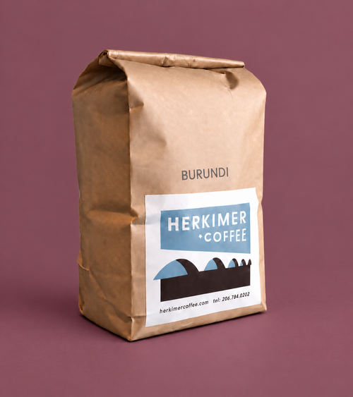 Burundi whole bean coffee by Herkimer Coffee on a colored studio background