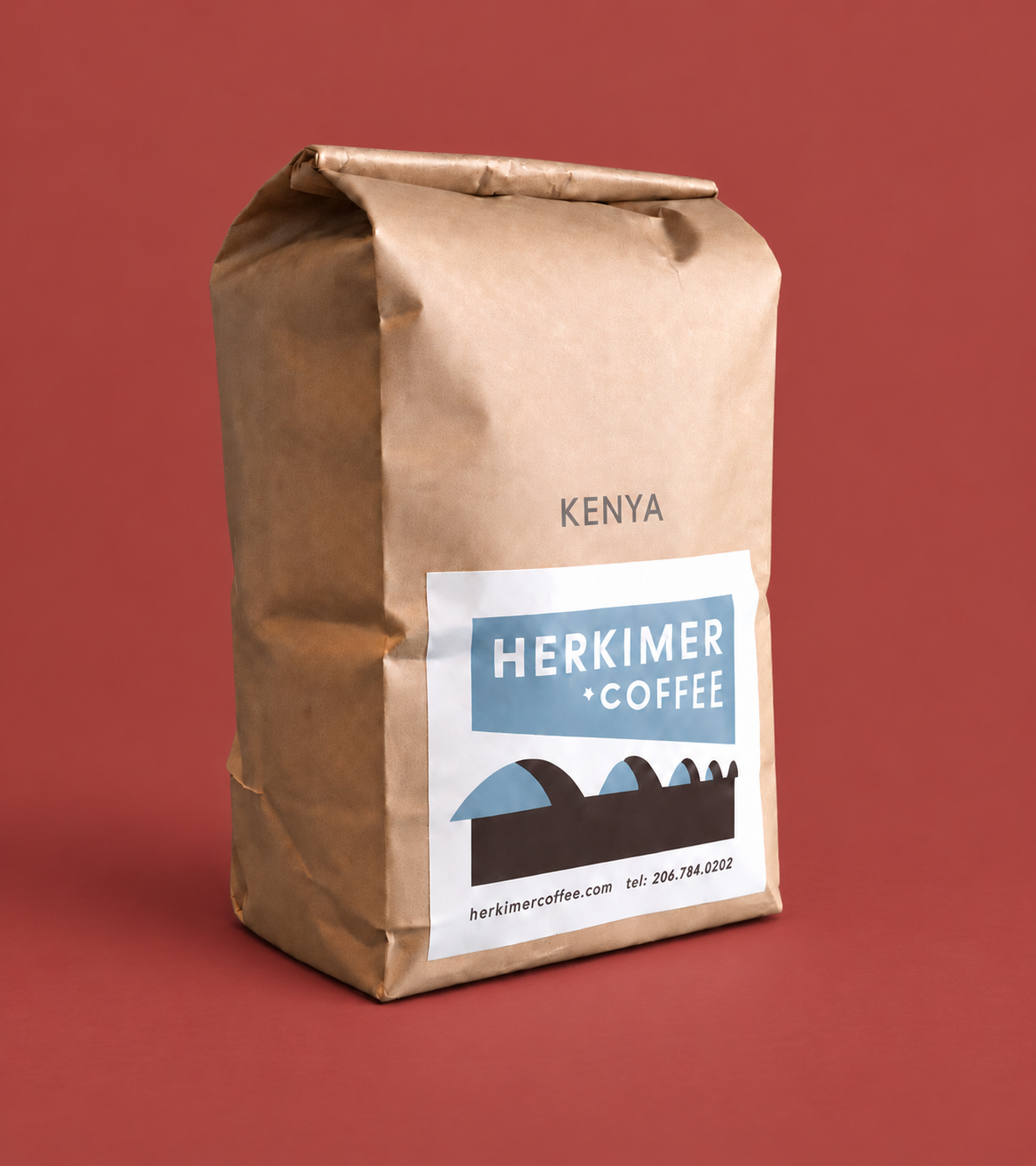 Kenya whole bean coffee by Herkimer Coffee on a colored studio background