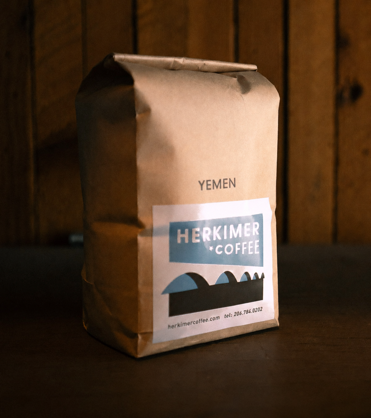 Yemen whole bean coffee by Herkimer Coffee on a wooden background